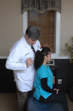 Dr. Barone providing chiropractic care to a patient at 1st Care Chiropractic